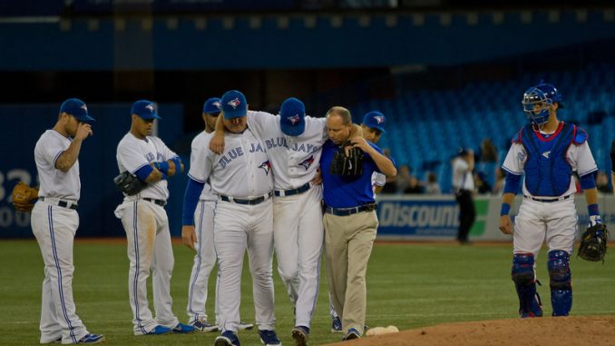 Toronto Blue Jays starting pitcher Brandon Morrow is helped off the field after taking a direct hit off a line drive in the seventh inning. The right-handed pitcher and team officials feared the worst but x-rays were negative. Toronto won 4-1 to sweep the Baltimore Orioles at Rogers Centre (JP Dhanoa)